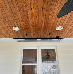 Wood ceiling with recessed lights and black track lighting